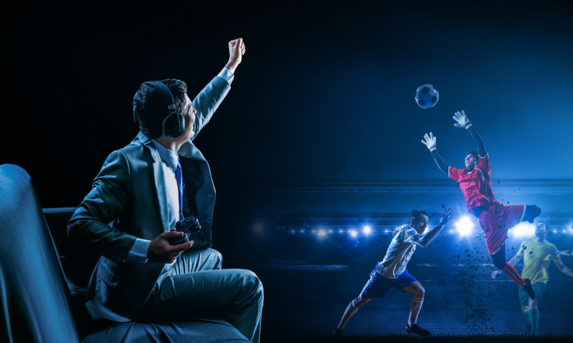 A man playing football (soccer) video game on controller, cheering