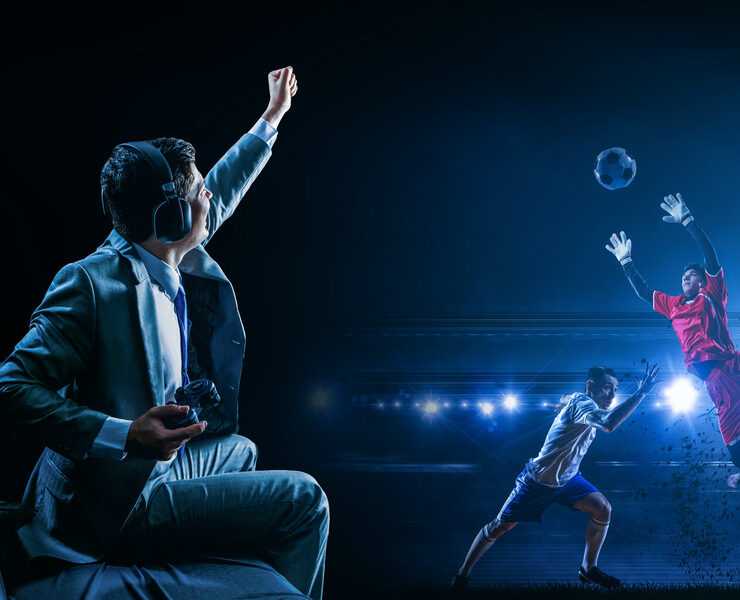 A man playing football (soccer) video game on controller, cheering