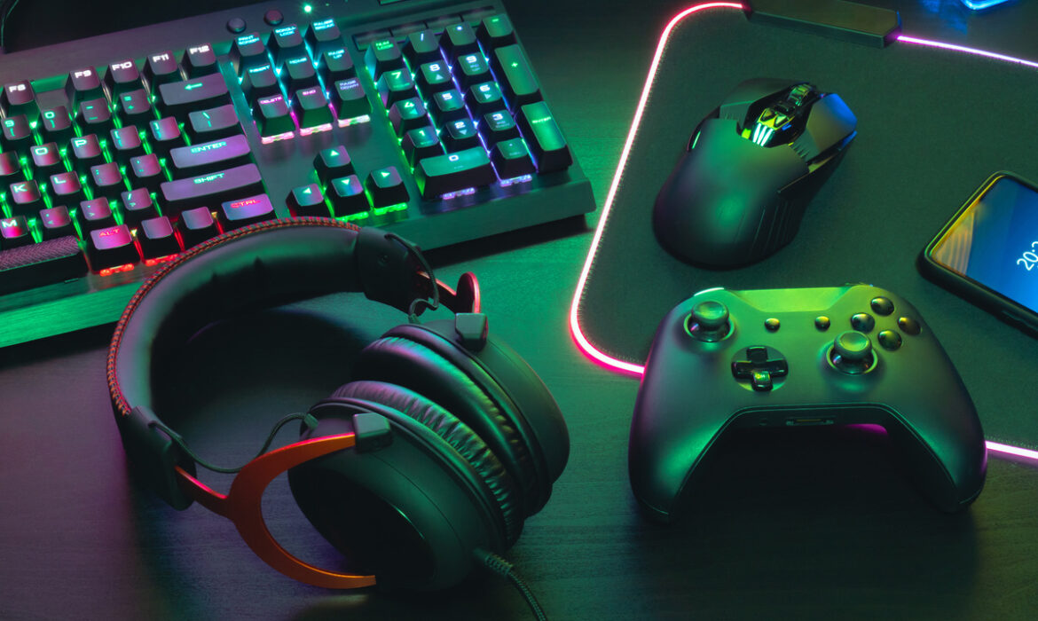 video game player's desk with keyboard, mouse, headphones and controller