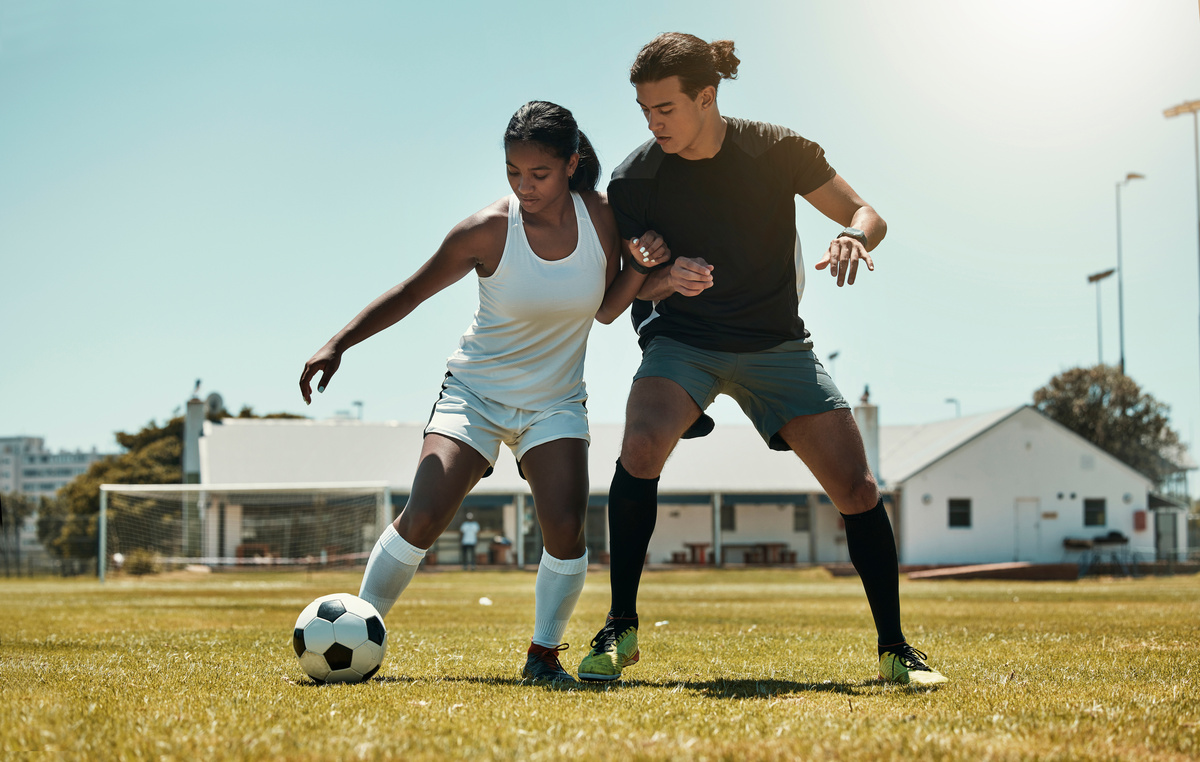 Man, woman and playing soccer on grass park