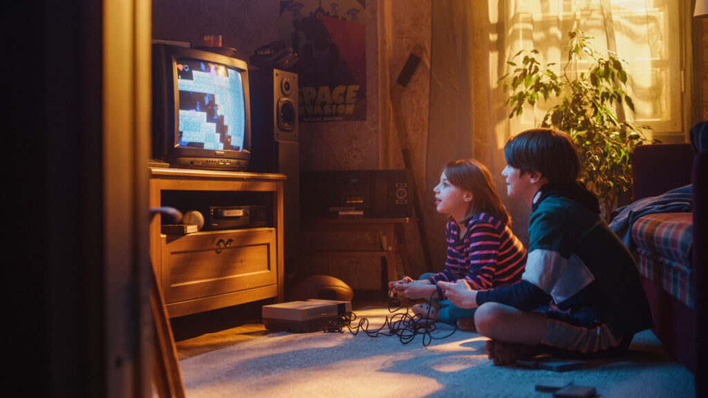 Kids playing a 2D retro game