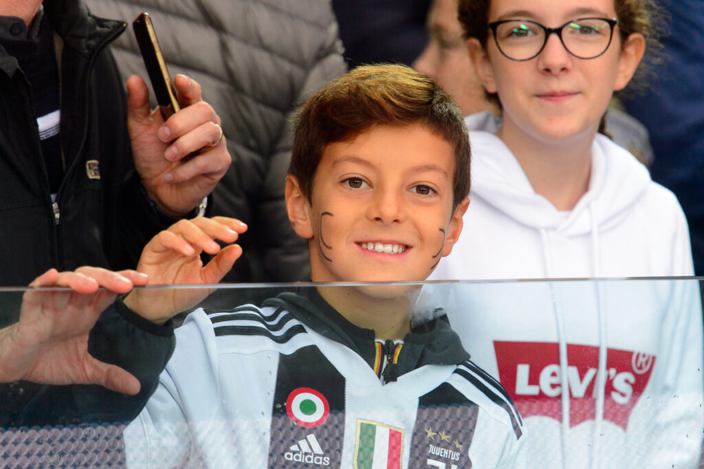 a child in Juventus shirt smiling