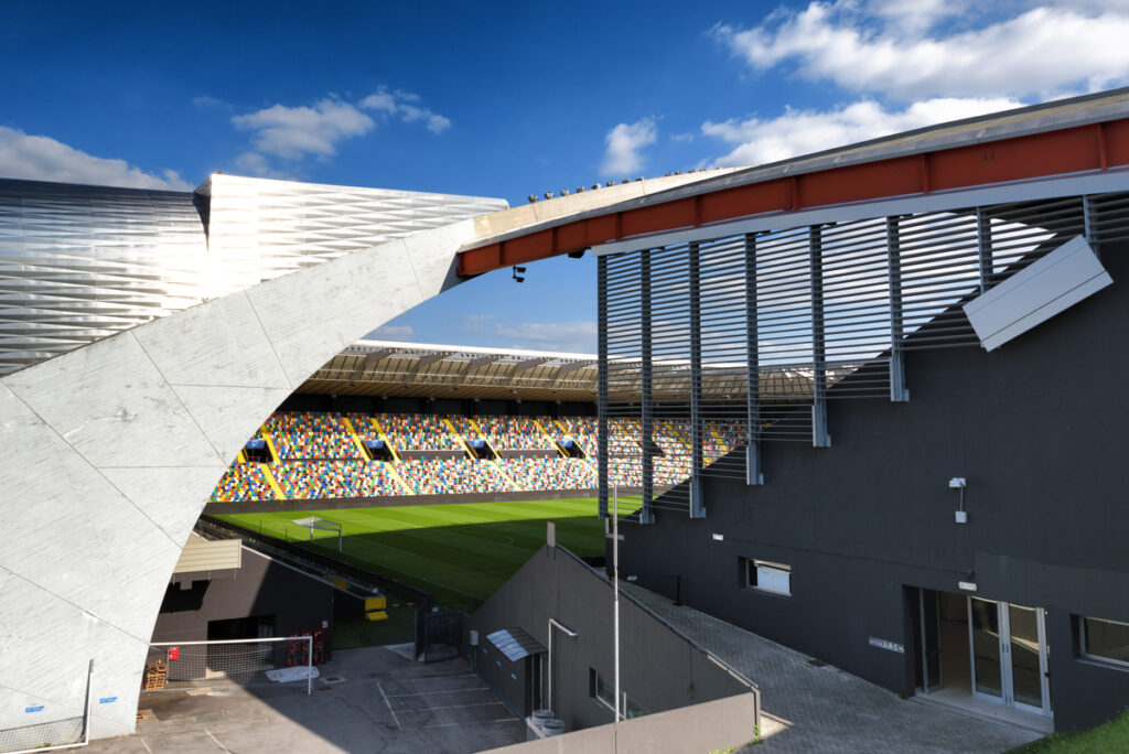 pitch and stands viewed through the entrance on the stadium. 