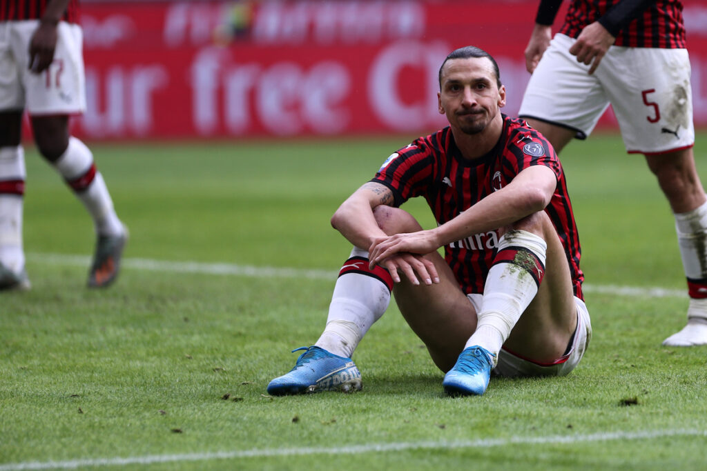 AC Milan player Zlatan Ibrahimovic sitting on the pitch