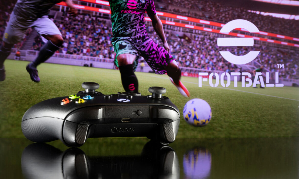 Xbox controller with efootball in background