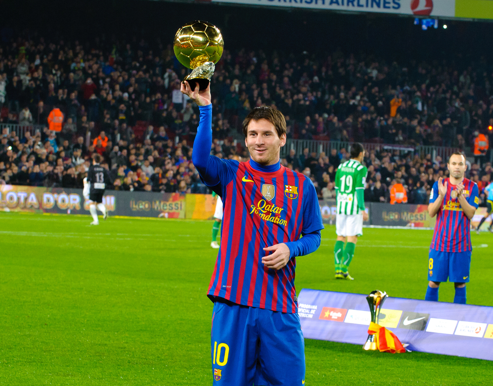 Leo Messi poses with FIFA World Player Gold Ball Award in Camp Nou stadium before the match between FC Barcelona vs Betis