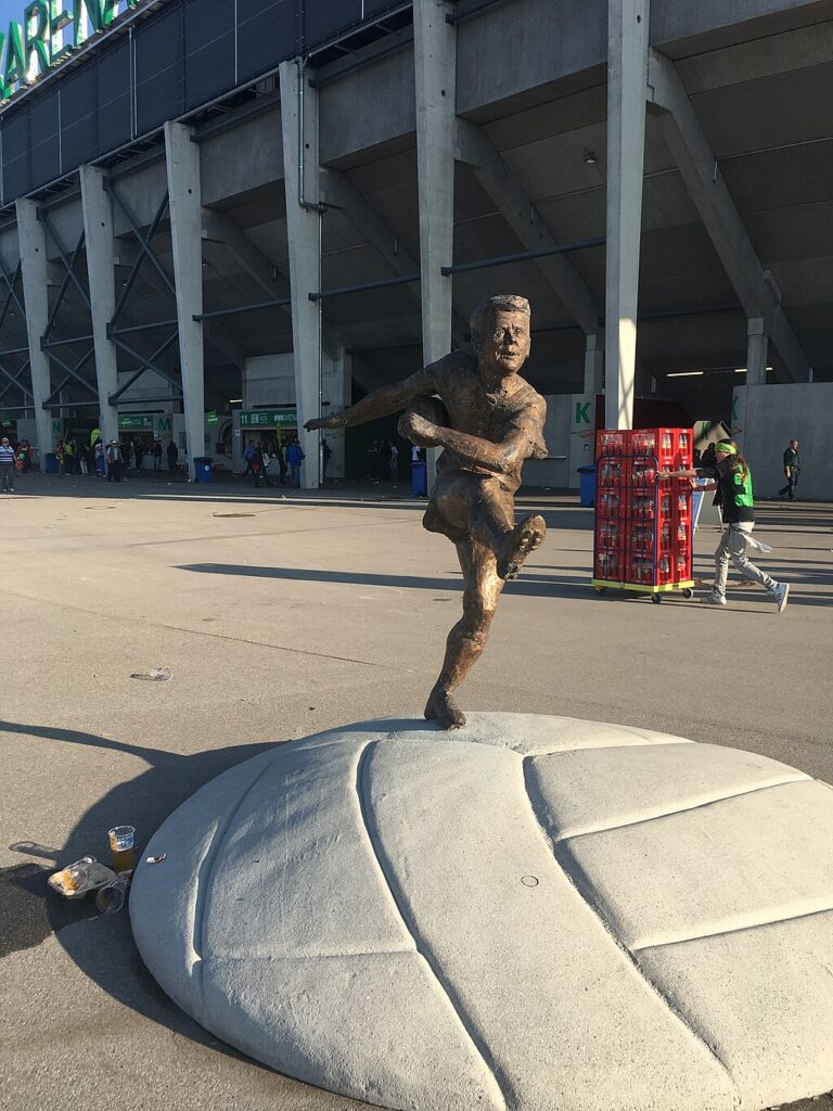 A footballer statue outside the WWK Arena