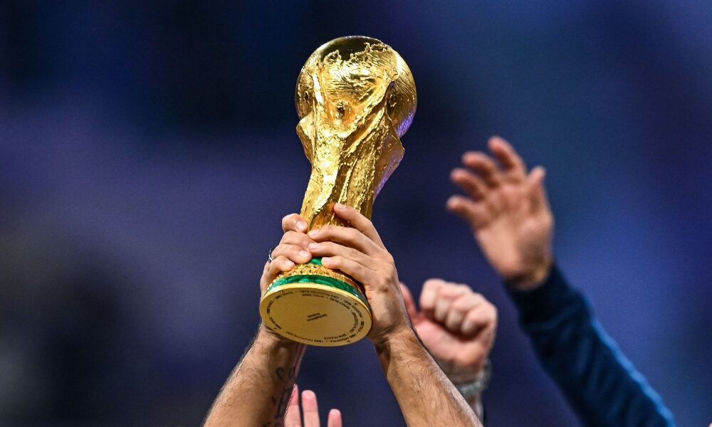 person holding the FIFA World Cup trophy