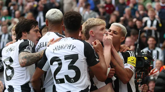 players hugging a teammate after scoring a goal