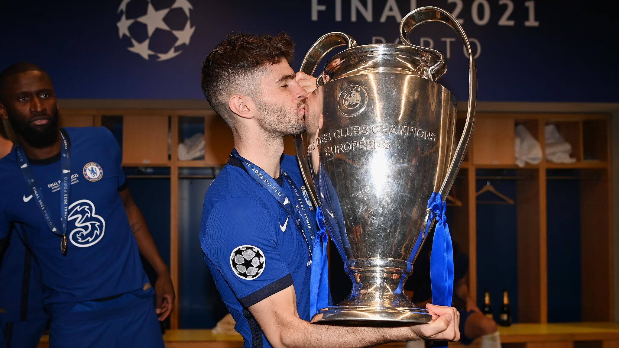 Chelsea player kissing a trophy from the UEFA tournament