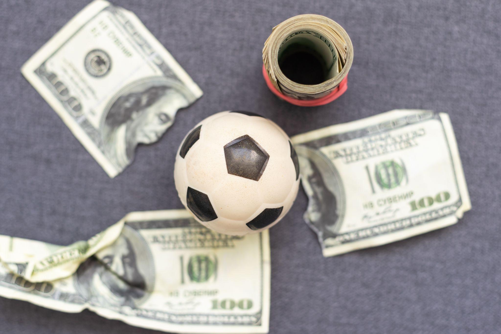 football on top of dollar bills
