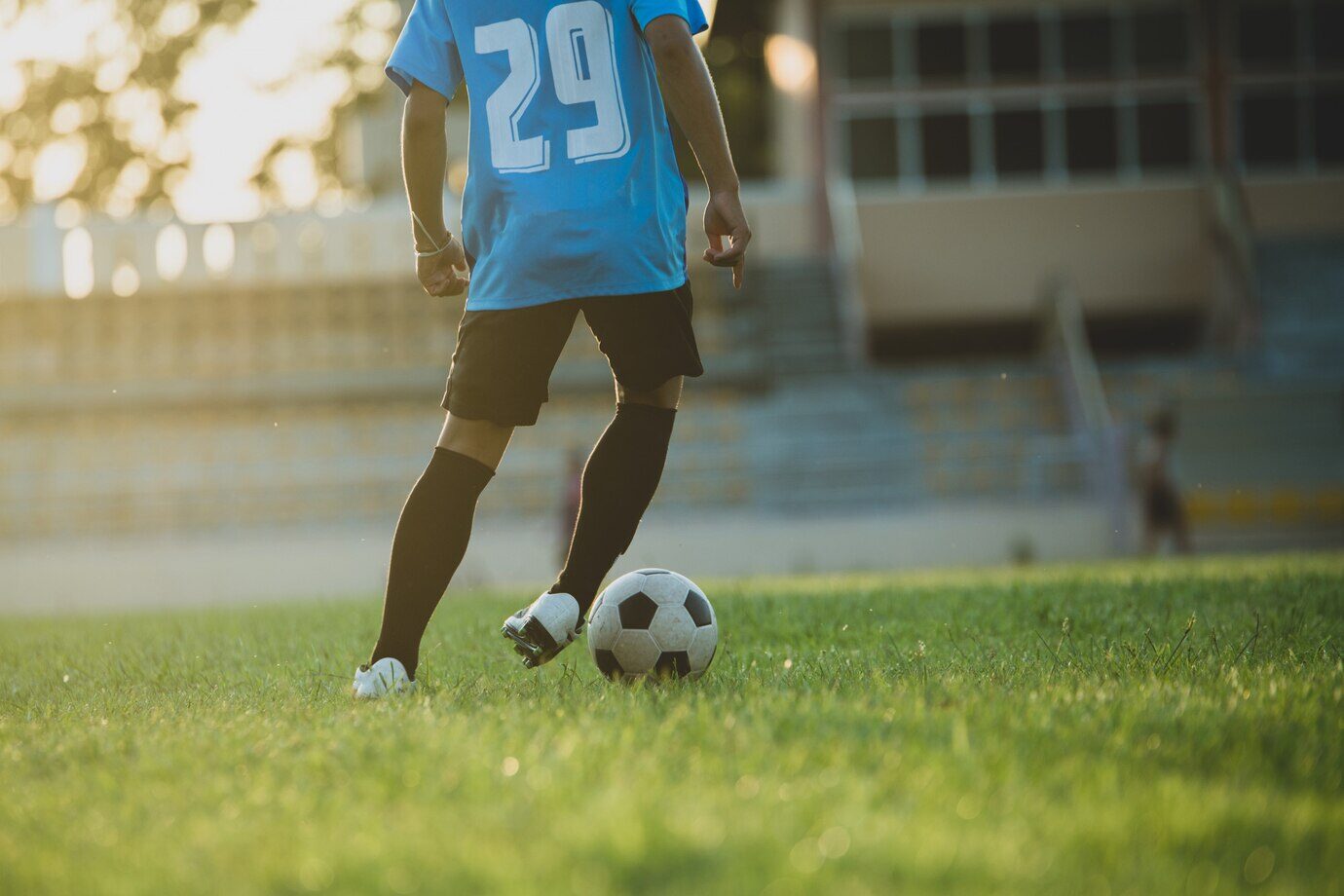 player training dribbling on the field