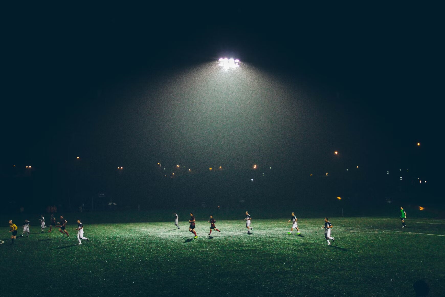 teams playing football during night