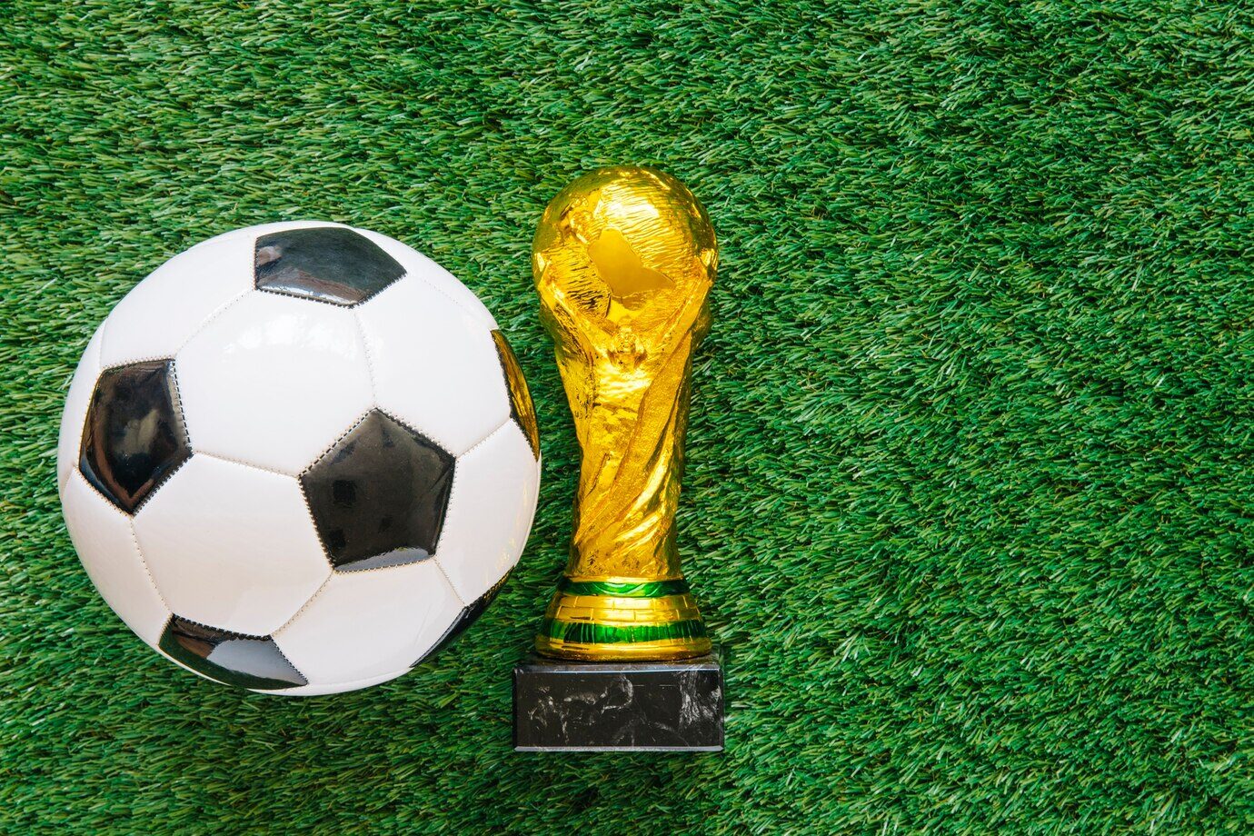 FIFA World Cup trophy alongside a ball