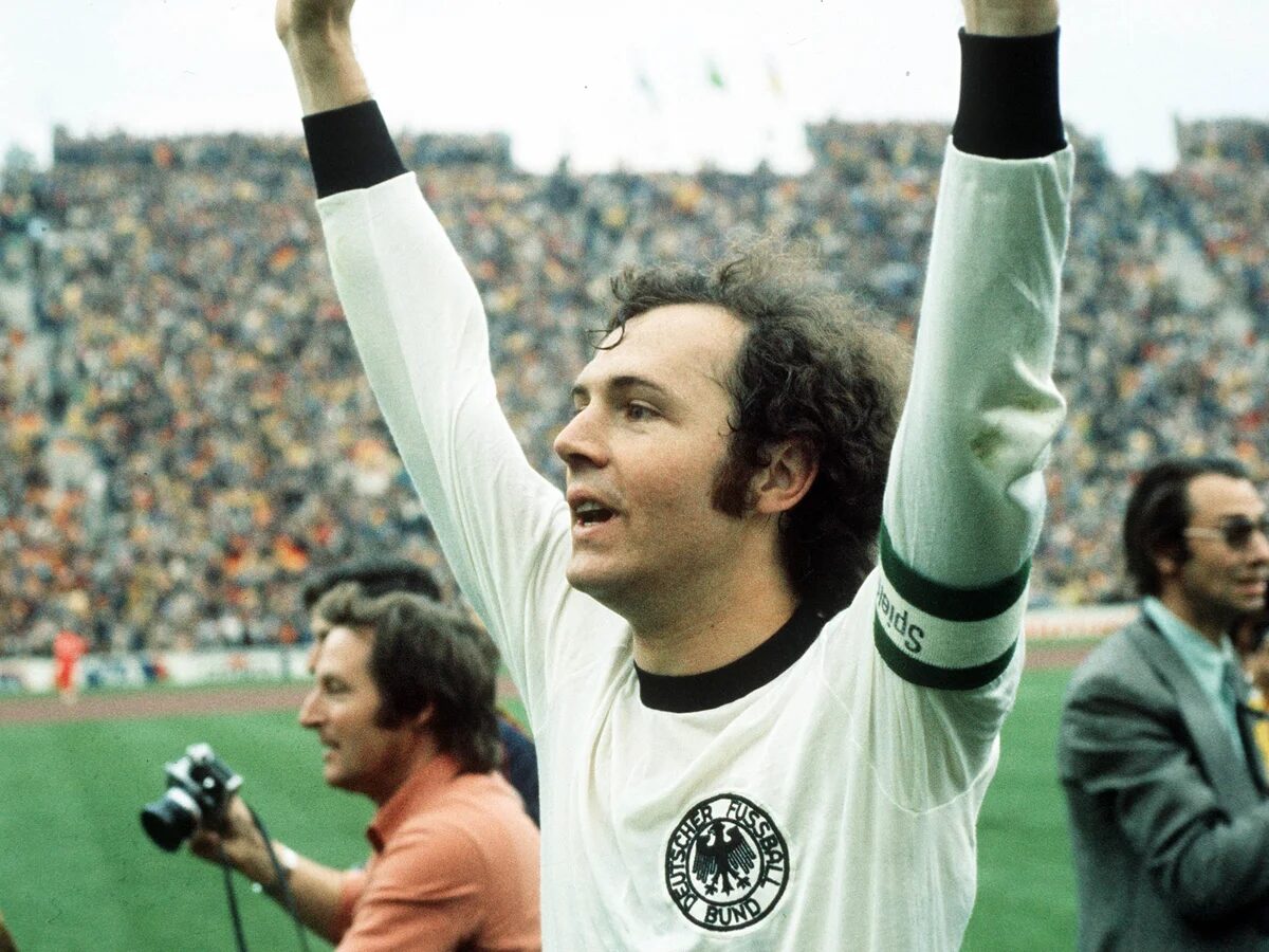 Franz Beckenbauer celebrating with his hands in the air