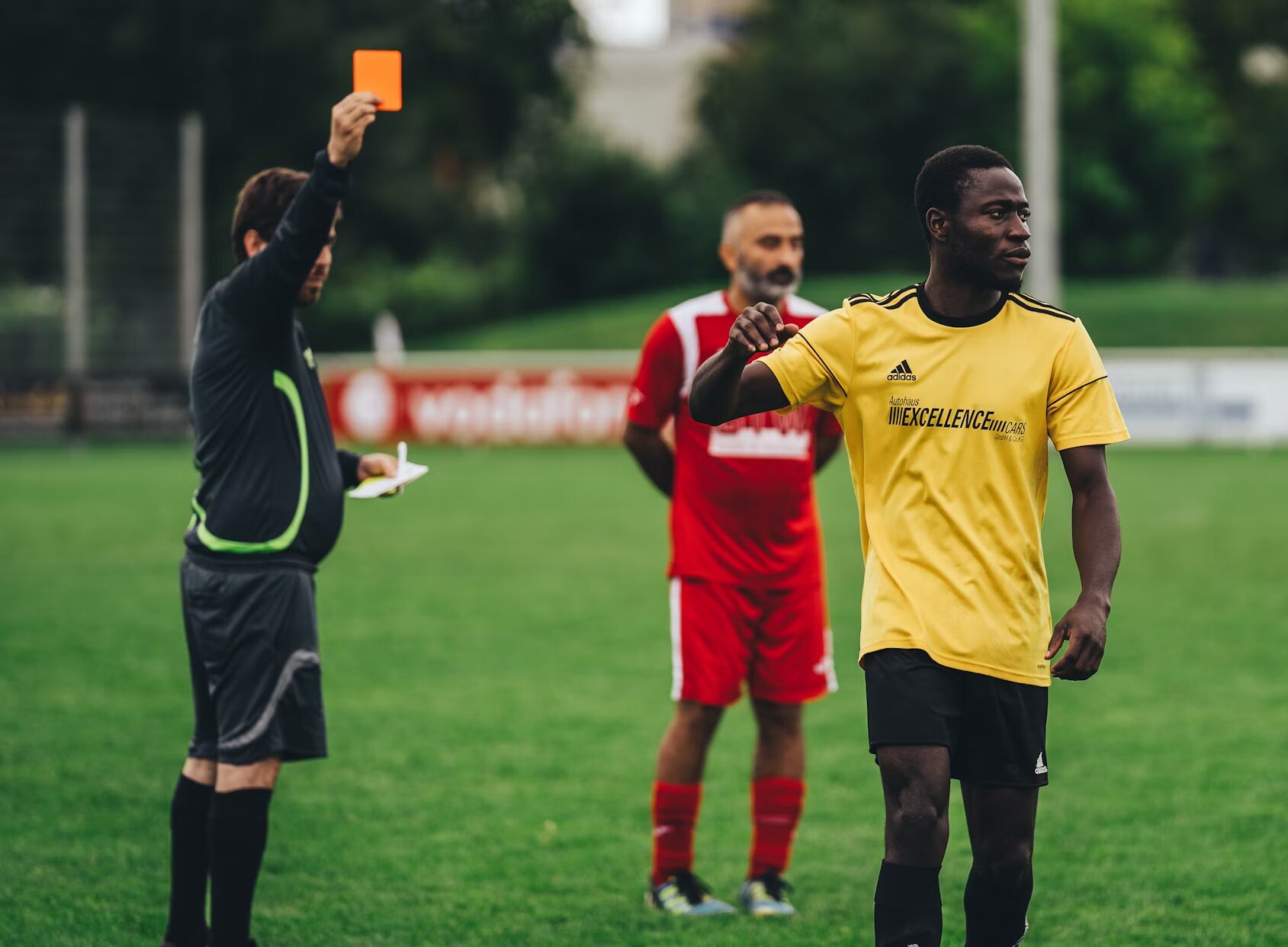 referee giving the player a red card
