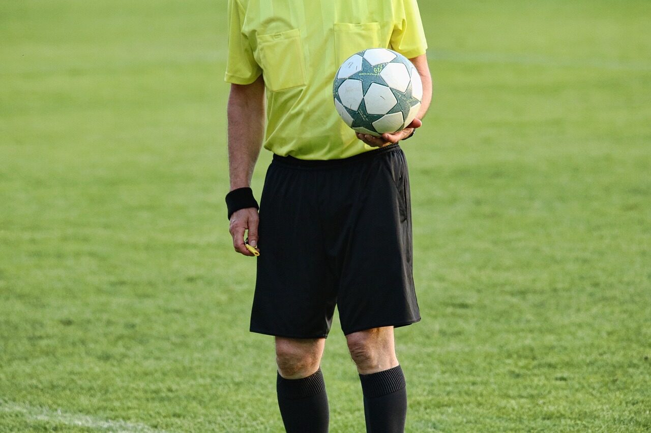 referee holding the ball during a game