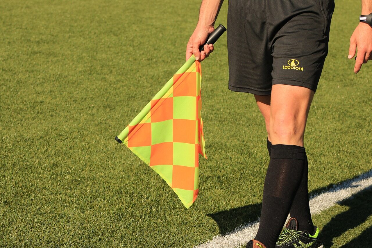 referee with a flag on the field