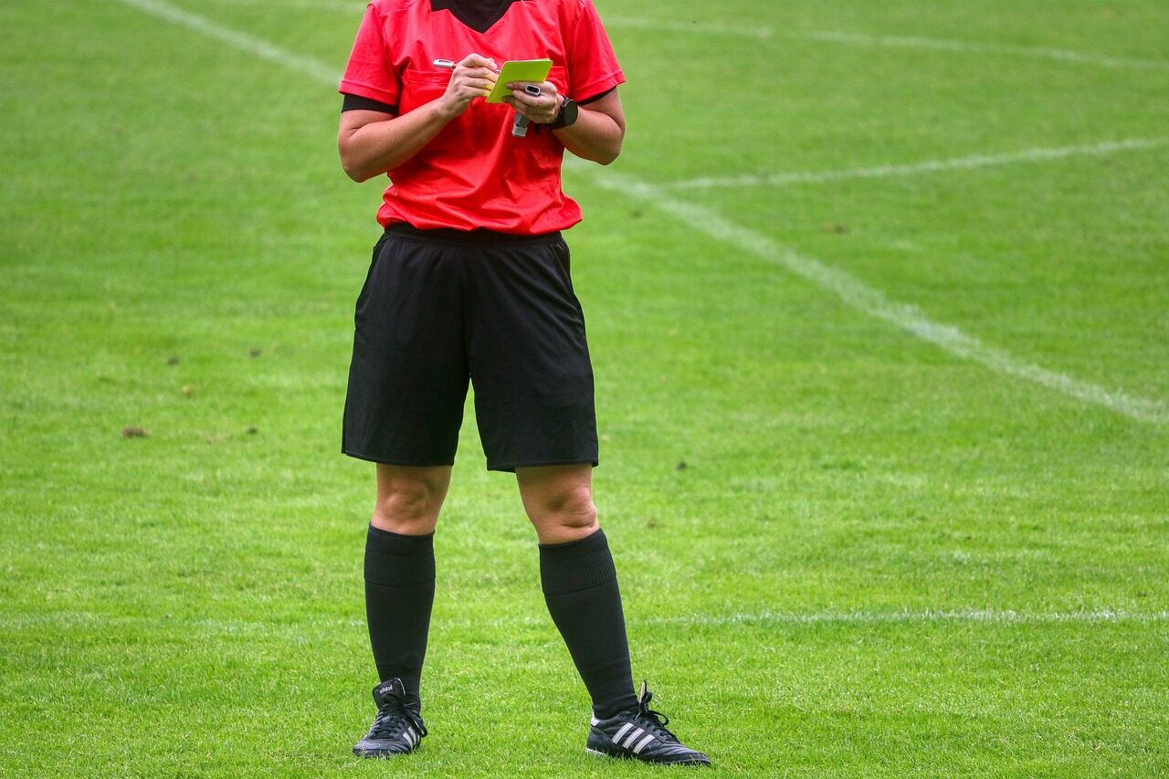 referee writing a yellow card