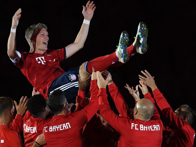 Schweinsteiger being thrown in the air by his teammate