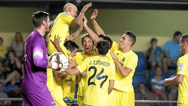 Villarreal players celebrating with a 13yo. boy